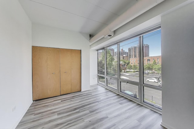 1430 S Michigan Ave Unit 311, Chicago, IL 60605 - unfurnished bedroom featuring a city view, wood finished floors, access to outside, and a closet