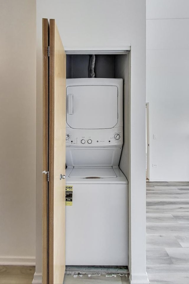 1430 S Michigan Ave Unit 311, Chicago, IL 60605 - laundry room featuring stacked washer and clothes dryer and wood finished floors