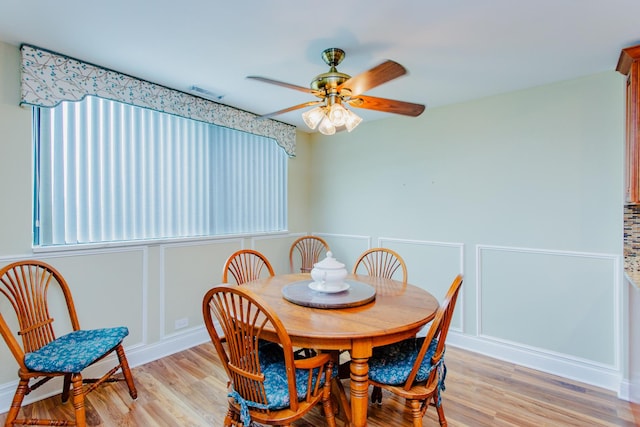 15 Bar Harbour Rd Unit 5A, Schaumburg, IL 60193 - dining room featuring ceiling fan, light wood-type flooring, and a decorative wall