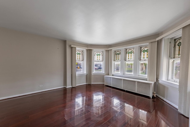 2535 Oak Park Ave, Berwyn, IL 60402 - empty room featuring radiator, baseboards, and wood finished floors