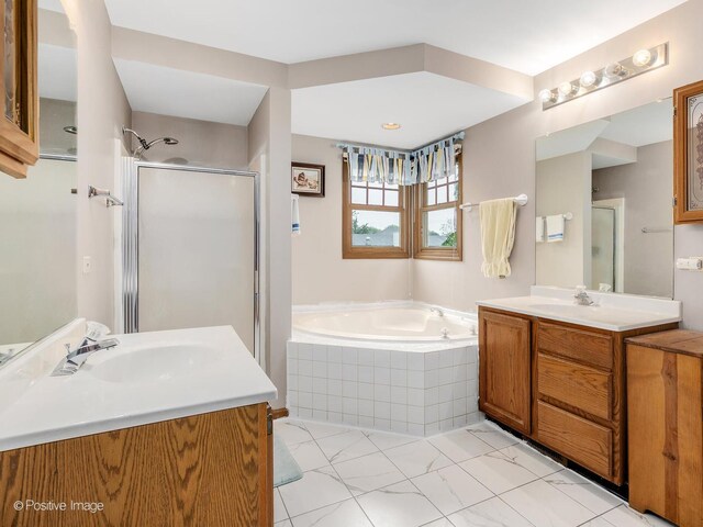 824 Dawes Ave, Wheaton, IL 60189 - full bathroom featuring two vanities, a garden tub, a shower stall, and marble look tile flooring
