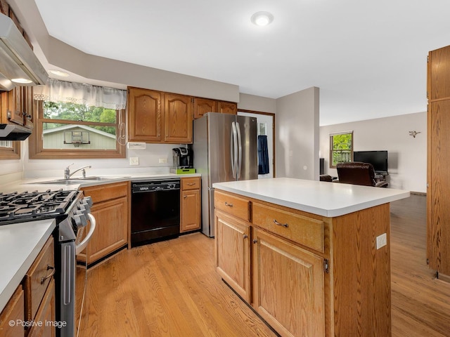 824 Dawes Ave, Wheaton, IL 60189 - kitchen featuring stainless steel appliances, light wood-type flooring, under cabinet range hood, and a center island
