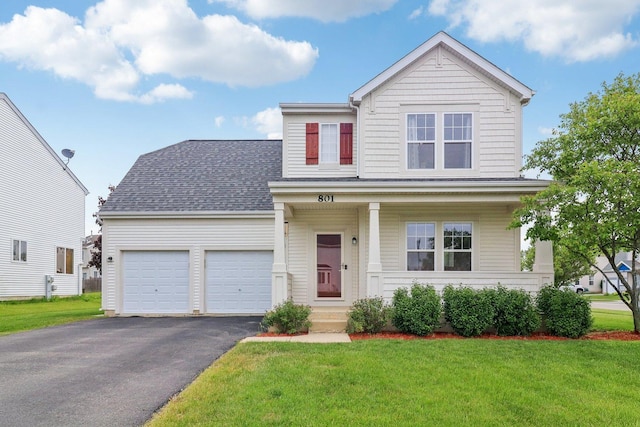 801 S Parkside Dr, Round Lake, IL 60073 - traditional-style house featuring asphalt driveway, an attached garage, a front yard, and a shingled roof