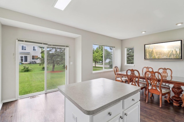 801 S Parkside Dr, Round Lake, IL 60073 - kitchen featuring dark wood finished floors, white cabinetry, a kitchen island, light countertops, and recessed lighting