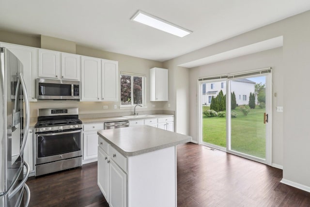 801 S Parkside Dr, Round Lake, IL 60073 - kitchen featuring stainless steel appliances, light countertops, a sink, and dark wood-type flooring