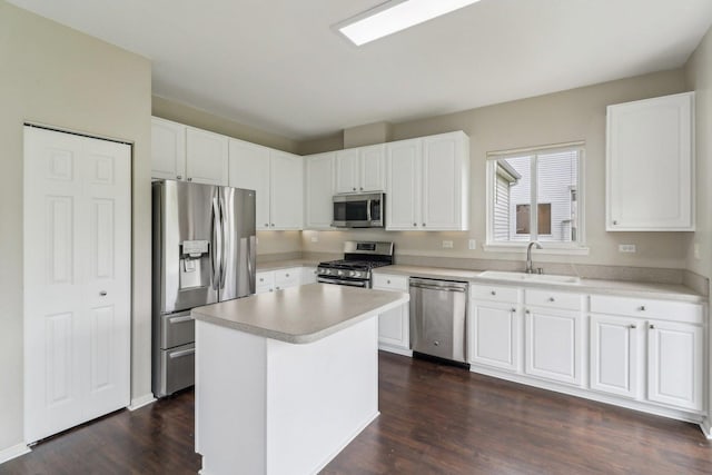801 S Parkside Dr, Round Lake, IL 60073 - kitchen with stainless steel appliances, a sink, dark wood-style floors, white cabinetry, and light countertops