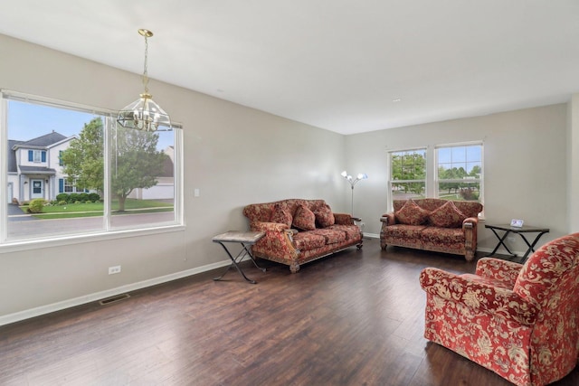801 S Parkside Dr, Round Lake, IL 60073 - living area with a chandelier, wood finished floors, and baseboards