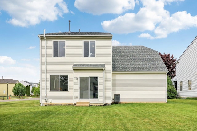 801 S Parkside Dr, Round Lake, IL 60073 - rear view of house with a lawn, cooling unit, and roof with shingles