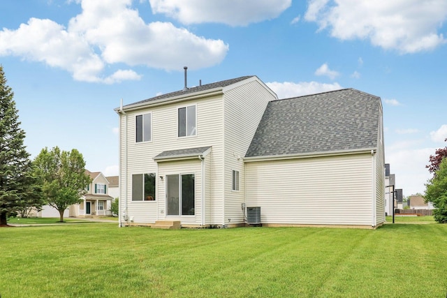 801 S Parkside Dr, Round Lake, IL 60073 - rear view of house with central air condition unit, a lawn, a shingled roof, and entry steps