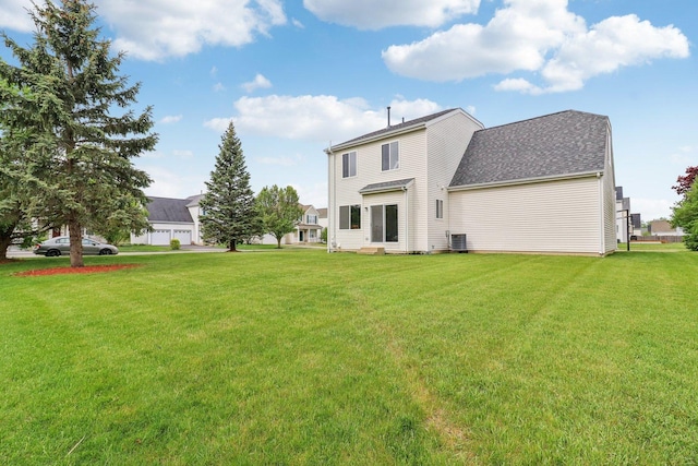 801 S Parkside Dr, Round Lake, IL 60073 - rear view of property with a yard and central AC unit