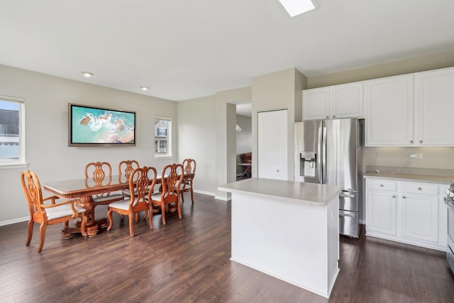 801 S Parkside Dr, Round Lake, IL 60073 - kitchen with stainless steel fridge, dark wood-type flooring, light countertops, a kitchen island, and recessed lighting