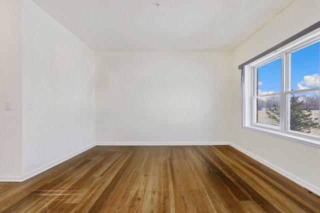 1005 Regent Dr, Matteson, IL 60443 - spare room featuring baseboards and dark wood finished floors