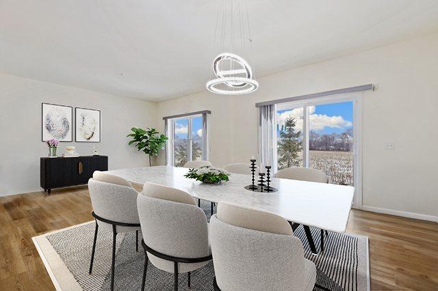 1005 Regent Dr, Matteson, IL 60443 - dining room with a chandelier, light wood-style flooring, and baseboards