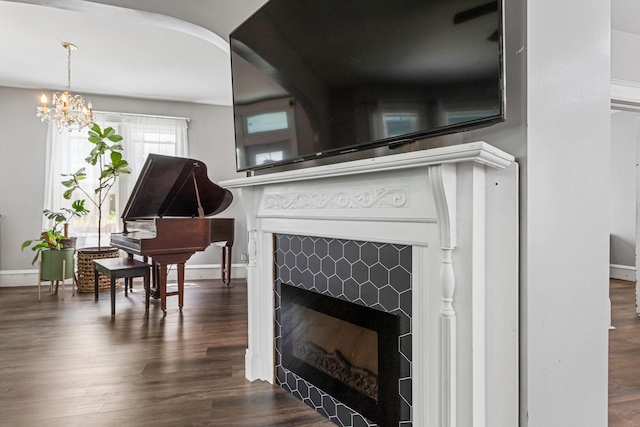 1104 W Church St, Champaign, IL 61821 - detailed view of a fireplace, a chandelier, baseboards, and wood finished floors