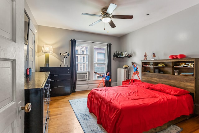 1104 W Church St, Champaign, IL 61821 - bedroom with radiator, wood finished floors, and ceiling fan
