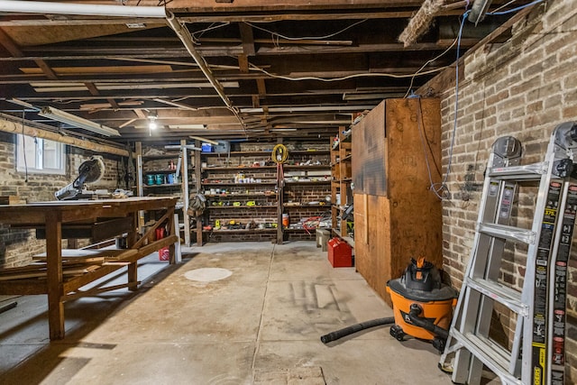 1104 W Church St, Champaign, IL 61821 - below grade area featuring a workshop area and brick wall