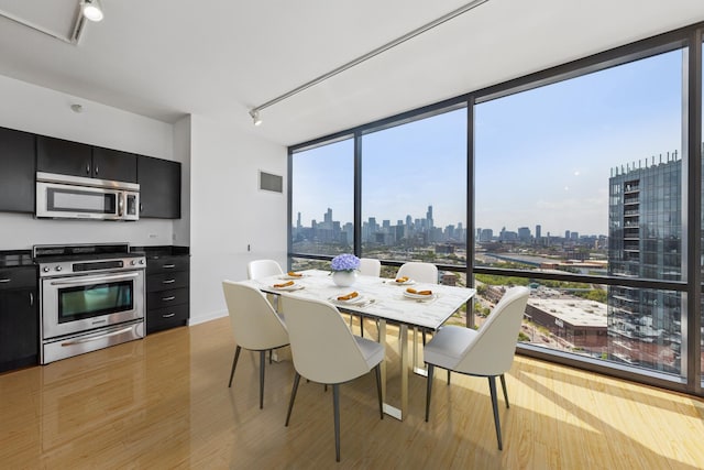 860 W Blackhawk St Unit 2102, Chicago, IL 60642 - dining area with a view of skyline and light wood-type flooring