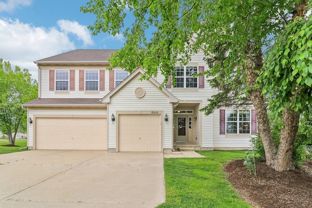 8610 Pebble Creek Ct, Wonder Lake, IL 60097 - view of front of house featuring concrete driveway, an attached garage, and a front yard