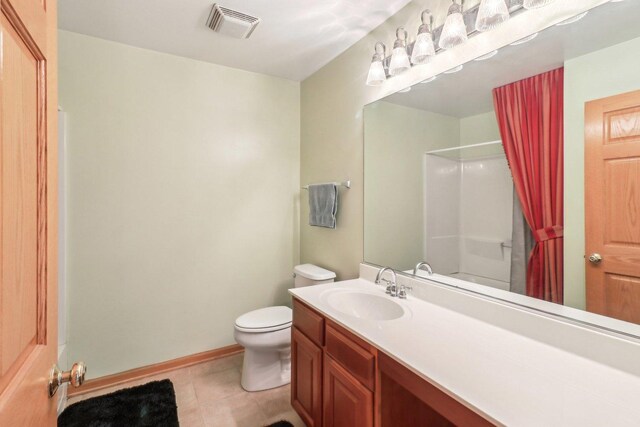 8610 Pebble Creek Ct, Wonder Lake, IL 60097 - bathroom featuring toilet, vanity, a shower with shower curtain, tile patterned flooring, and baseboards