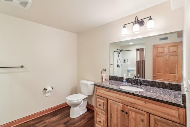 8610 Pebble Creek Ct, Wonder Lake, IL 60097 - bathroom with wood finished floors, toilet, vanity, curtained shower, and baseboards