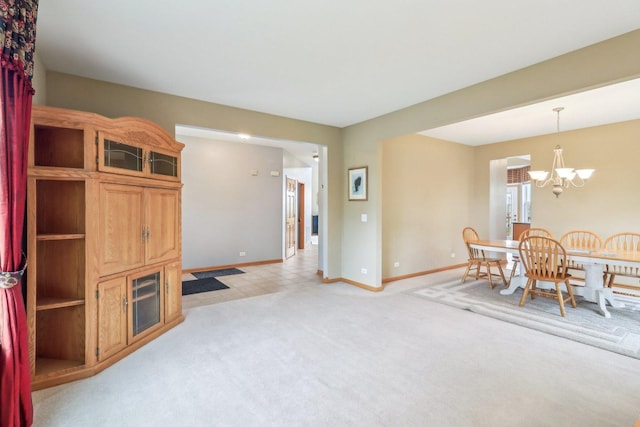 8610 Pebble Creek Ct, Wonder Lake, IL 60097 - dining area featuring a chandelier, baseboards, light colored carpet, and light tile patterned floors