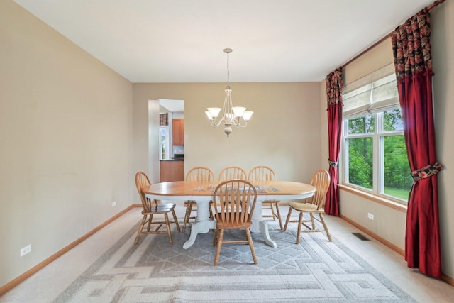 8610 Pebble Creek Ct, Wonder Lake, IL 60097 - dining area featuring a chandelier, baseboards, and light colored carpet
