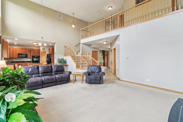 8610 Pebble Creek Ct, Wonder Lake, IL 60097 - living area featuring a towering ceiling, light carpet, stairs, and baseboards