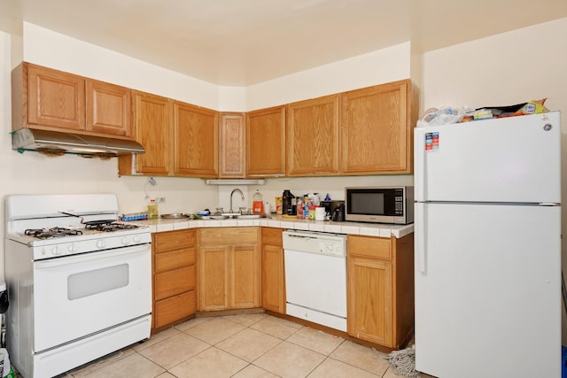 3307 S Wallace St, Chicago, IL 60616 - kitchen with white appliances, under cabinet range hood, a sink, light tile patterned flooring, and tile counters