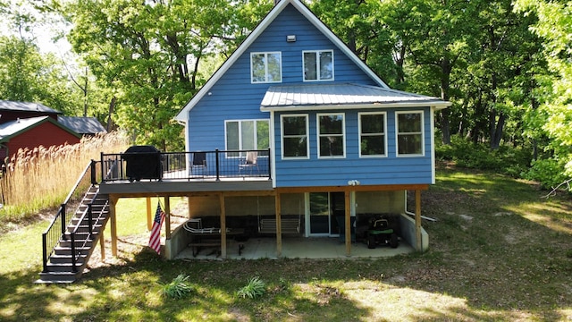 22 Cedar Ln, Putnam, IL 61560 - rear view of house featuring stairway, a wooden deck, metal roof, a patio, and a lawn
