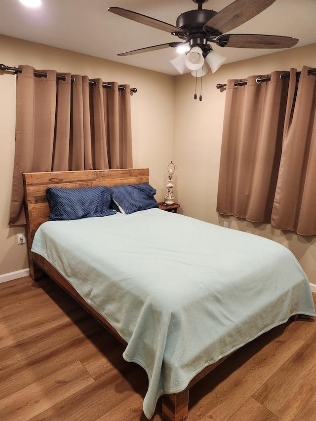 22 Cedar Ln, Putnam, IL 61560 - bedroom with wood finished floors, a ceiling fan, and baseboards