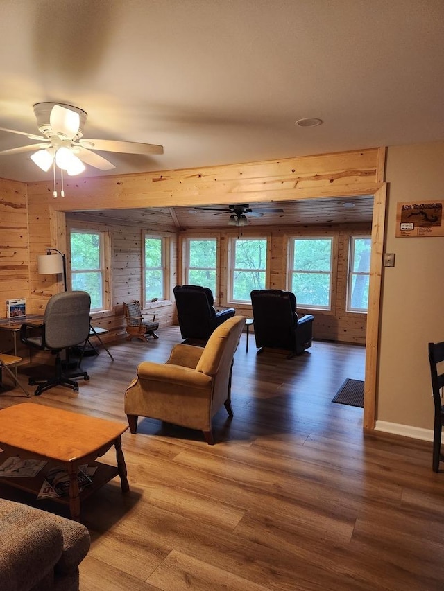 22 Cedar Ln, Putnam, IL 61560 - living room featuring wood finished floors, wood walls, plenty of natural light, and ceiling fan