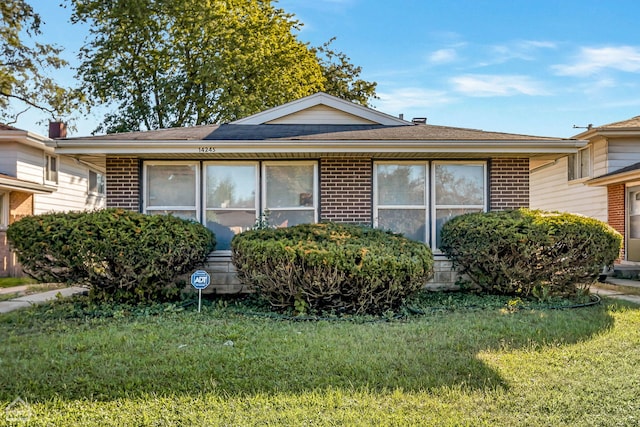 14245 Cottage Grove Ave, Dolton, IL 60419 - view of front of house featuring brick siding, a front yard, and a shingled roof