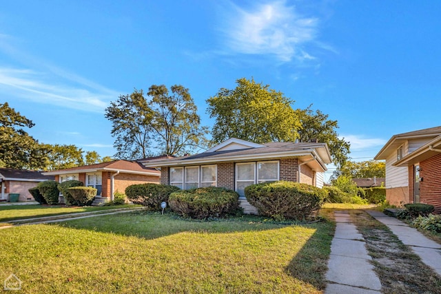 14245 Cottage Grove Ave, Dolton, IL 60419 - view of front facade with brick siding and a front lawn