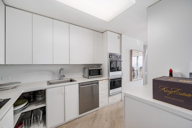 2400 N Lakeview Ave Unit 2803-04, Chicago, IL 60614 - kitchen with appliances with stainless steel finishes, white cabinetry, light countertops, and light wood-type flooring