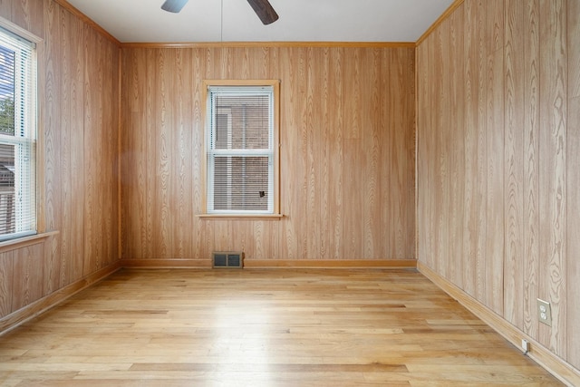 3229 N Oketo Ave, Chicago, IL 60634 - spare room with wood finished floors, a ceiling fan, baseboards, and wood walls