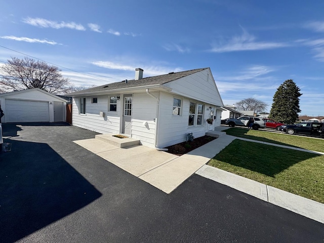 8758 S Corcoran Rd Unit 2, Hometown, IL 60456 - view of front of house featuring driveway, an outdoor structure, a garage, a front lawn, and a shingled roof