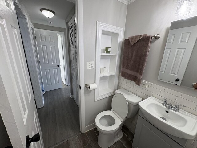 8758 S Corcoran Rd Unit 2, Hometown, IL 60456 - half bathroom with wood finished floors, toilet, vanity, and baseboards