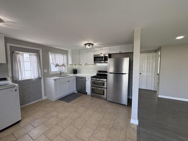 8758 S Corcoran Rd Unit 2, Hometown, IL 60456 - kitchen with stainless steel appliances, washer / clothes dryer, a sink, white cabinets, and light countertops