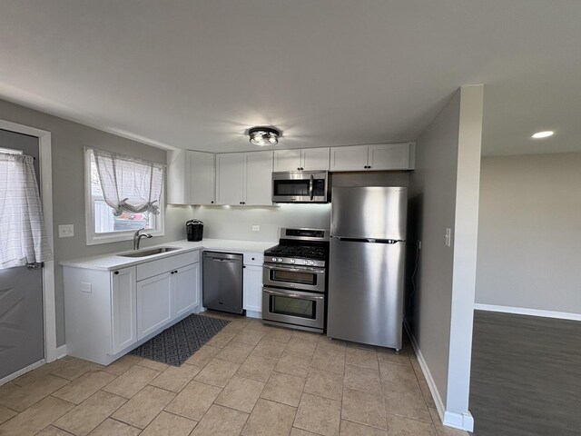 8758 S Corcoran Rd Unit 2, Hometown, IL 60456 - kitchen featuring stainless steel appliances, a sink, white cabinetry, light countertops, and baseboards