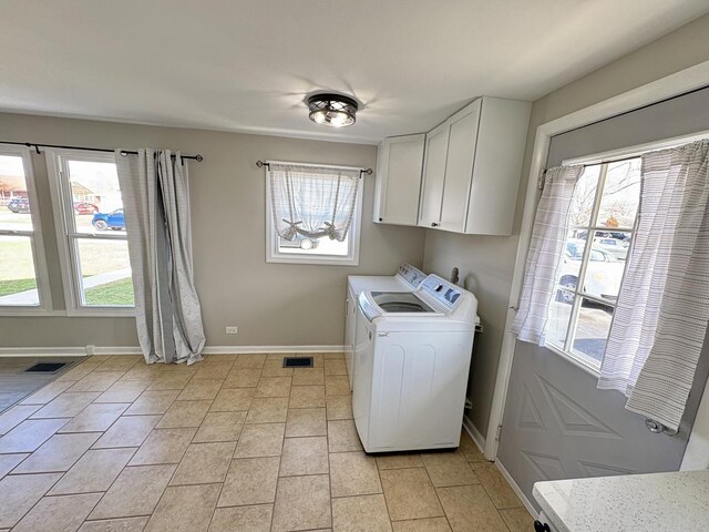 8758 S Corcoran Rd Unit 2, Hometown, IL 60456 - washroom featuring washing machine and dryer, cabinet space, baseboards, and light tile patterned flooring