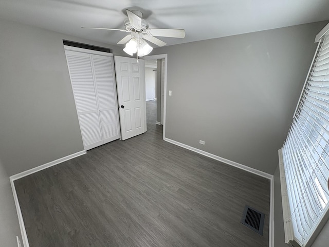 8758 S Corcoran Rd Unit 2, Hometown, IL 60456 - unfurnished bedroom featuring multiple windows, dark wood-style floors, and baseboards