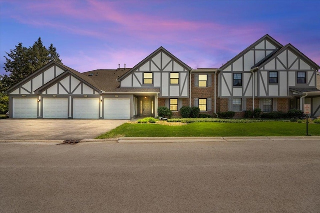 466 Elizabeth Dr Unit 17-C, Wood Dale, IL 60191 - view of front of home featuring a lawn, driveway, an attached garage, and brick siding