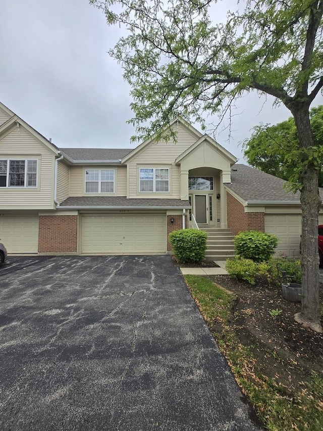 1639 Colfax Ct Unit 3, Bartlett, IL 60103 - view of front of property with brick siding, a garage, driveway, and a shingled roof