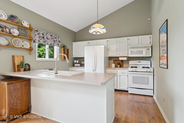 6S024 Westwind Dr, Naperville, IL 60563 - kitchen featuring white appliances, a peninsula, white cabinets, wood finished floors, and high vaulted ceiling