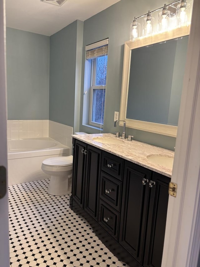 2804 Misty Brook Ln, Joliet, IL 60432 - bathroom featuring a garden tub, double vanity, tile patterned floors, and toilet