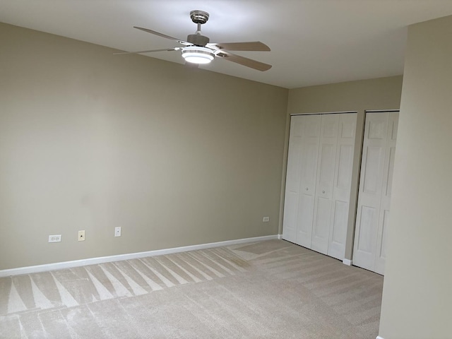 2804 Misty Brook Ln, Joliet, IL 60432 - unfurnished bedroom featuring light colored carpet, multiple closets, baseboards, and ceiling fan
