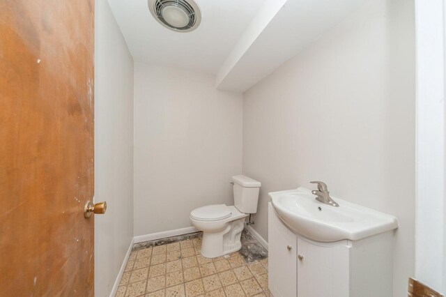 948 Carney Ave, Waukegan, IL 60085 - bathroom featuring tile patterned floors, vanity, toilet, and baseboards