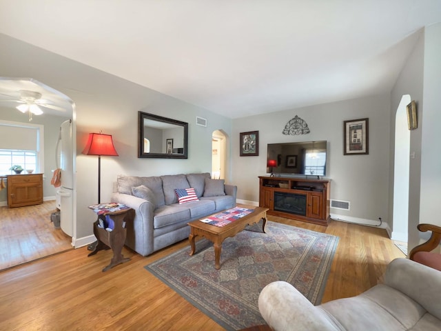 505 S Oakland Ave, Villa Park, IL 60181 - living room featuring arched walkways, light wood-style flooring, baseboards, and a ceiling fan