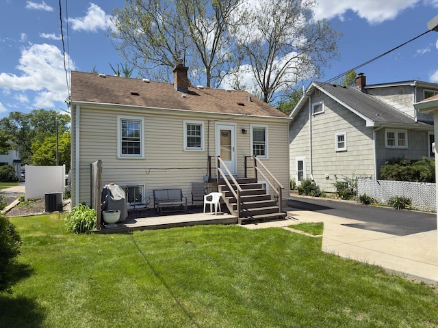 505 S Oakland Ave, Villa Park, IL 60181 - back of house featuring a chimney, a yard, central air condition unit, and roof with shingles