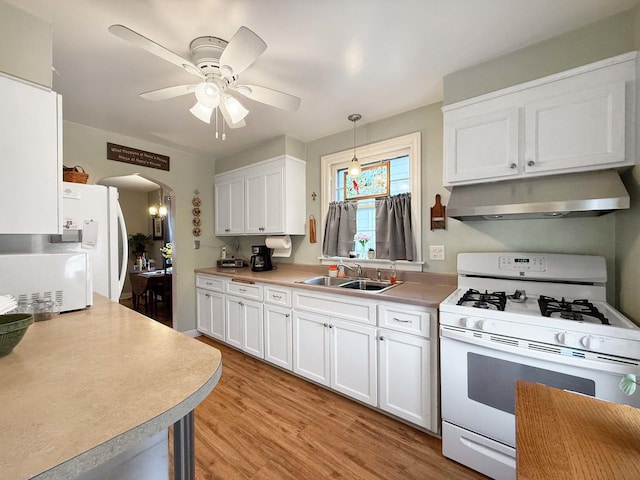 505 S Oakland Ave, Villa Park, IL 60181 - kitchen featuring white appliances, under cabinet range hood, a sink, white cabinetry, and light wood finished floors